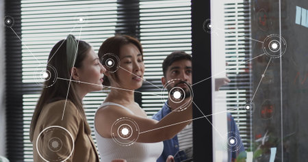 Image of connections and data processing over diverse business people in office. Global finance, business, connections, computing and data processing concept digitally generated image.の写真素材