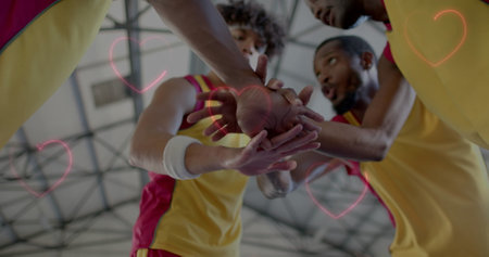 Image of hearts over diverse basketball players on court. Global sports, competition, connections, computing and data processing concept digitally generated image.の写真素材