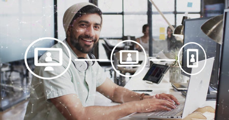 Image of network of connections with icons over diverse colleagues working in office. Technology and digital interface concept digitally generated image.の写真素材