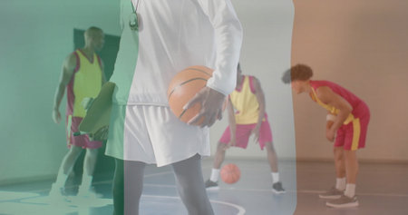 Image of flag of ireland over diverse basketball players on court. Global sports, competition,...