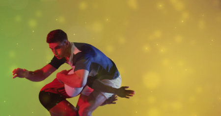 Image of glowing lights over male rugby players with ball. Sports, competition and active lifestyle concept digitally generated image.の写真素材