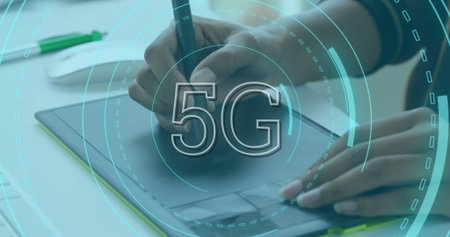 Image of 5g text in loading circles over midsection of caucasian man drawing on graphics tablet....