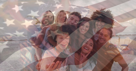 Image of flag of usa over happy diverse friends taking selfie on beach. American patriotism, summer and diversity concept digitally generated image.の写真素材
