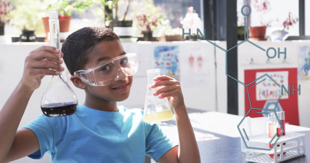 Holding flasks with liquids, boy in goggles with chemical structure image. science, chemistry, experiment, education, research, laboratoryの写真素材