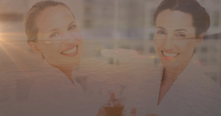 Image of light trails and caucasian businesswomen over sea. Lifestyle and free time concept digitally generated image.の写真素材