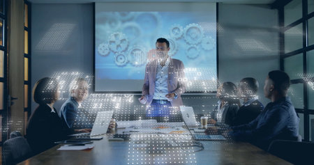 Image of binary coding data processing over diverse business people in office. Global finance, business, connections, computing and data processing concept digitally generated image.の写真素材