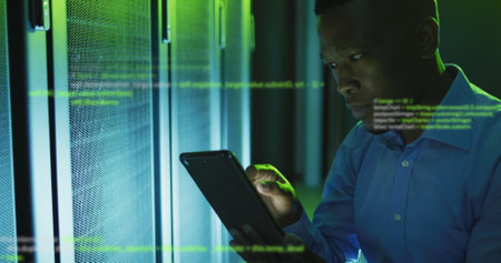 Image of data processing over african american male engineer using digital tablet at server room....
