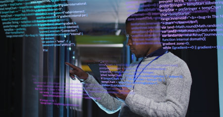 Image of data processing over african american male engineer using digital tablet at server room. Computer interface and business data storage technology conceptの写真素材
