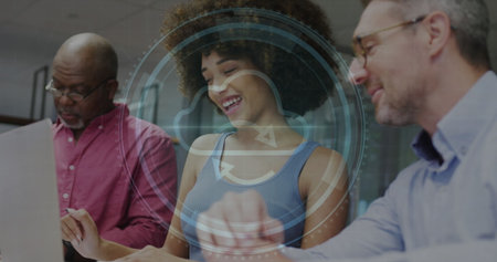 Image of cyber security text and firewall icon over diverse man and woman discussing at office....