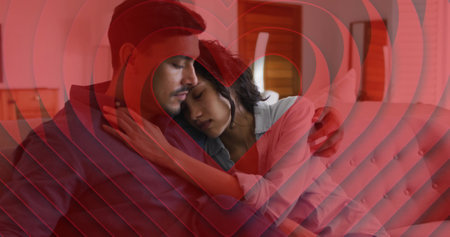 Image of hearts over diverse couple on sofa at home. Love, relationship, home and lifestyle concept digitally generated image.の写真素材