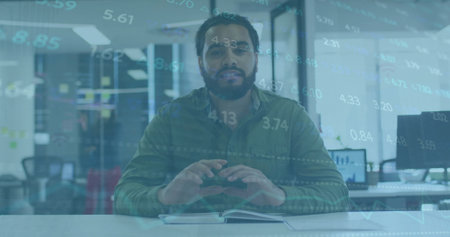 Image of stock market data over biracial businessman gesturing and explaining in office. Digital...