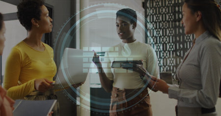 Image of cyber security text and firewall icon over diverse women discussing together at office....