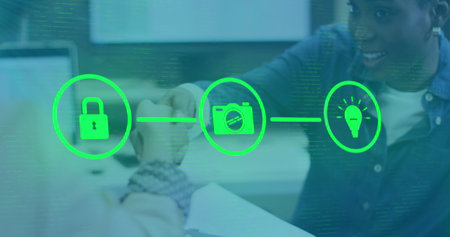 Image of flowchart of icons over diverse coworkers shaking hands in office. Digital composite, multiple exposure, communication, ideas, protection, teamwork and technology concept.の写真素材