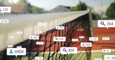 Image of changing numbers, icons in notification bars over tennis ball colliding with net. Digital composite, multiple exposure, business, social media reminder, sports and competition concept.の写真素材