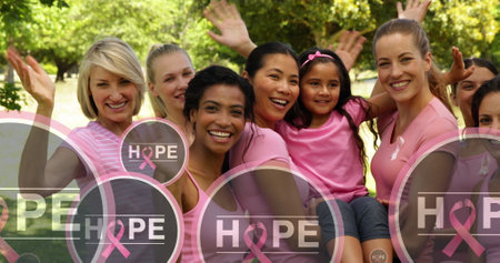 Image of hope text with pink ribbon logo, floating over diverse group of waving happy women. breast cancer positive female health awareness campaign concept digitally generated image.の写真素材