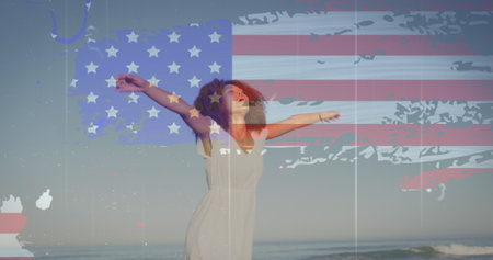 Image of american flag over african american woman raising hands at beach. patriotism and celebration concept digitally generated image.の写真素材
