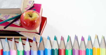 Image of pencils over school items on white background. education and school concept digitally generated image.の写真素材