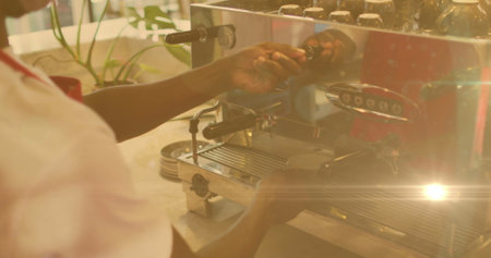 Image of lens flare and sunlight with hands of barista preparing coffee using machine. independent business concept, digitally generated image.の写真素材