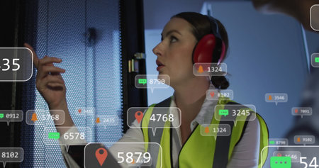 Image of social media icons over caucasian female it engineer with tablet by computer server....