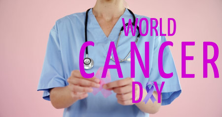 Image of world cancer day over midsection of caucasian female doctor with pink ribbon. cancer awareness and world cancer day concept digitally generated image.の写真素材
