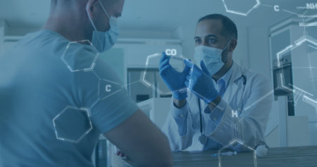 Image of chemical structures over biracial male doctor holding vaccine wearing face mask. Global covid 19 pandemic, medicine and healthcare services concept digitally generated image.の写真素材