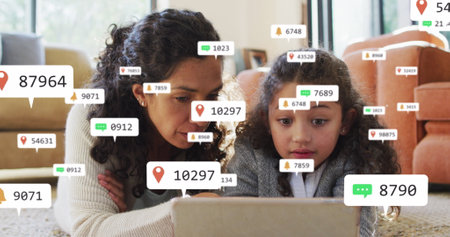 Image of icons with growing number over biracial woman and her daughter using tablet. Global social media and digital interface concept digitally generated image.の写真素材