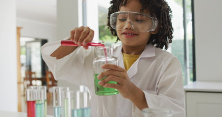 Image of shapes over african american schoolboy at science class. Global education, science and...