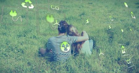 Image of ecology icons over caucasian couple embracing. Global ecology and digital interface concept digitally generated image.の写真素材