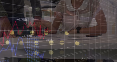Caucasian businesspeople discuss a document in modern office. one woman views fluctuating stock...