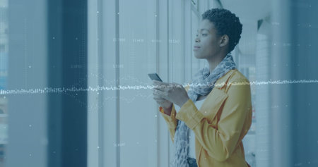 Image of financial data processing over biracial businessman using smartphone in office. Global...