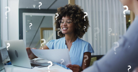 Image of question marks over diverse business people working at office. Global business, finances and digital interface concept digitally generated image.の写真素材