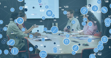 Image of network of icons over diverse colleagues discussing together at office. Global networking...