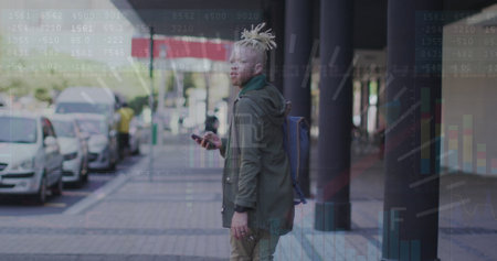 Image of graphs, numbers on african american man with cellphone looking back and walking in city. Digital composite, multiple exposure, report, business, abstract and technology concept.の写真素材