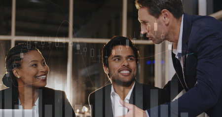 Image of financial graphs over happy diverse businesspeople talking in office. global business, finance, economy and technology concept digitally generated image.の写真素材