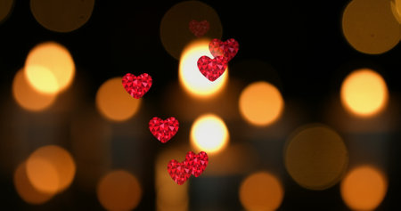 Image of hearts over spots and candles. new year&#39;s eve party celebrations concept digitally generated image.の写真素材