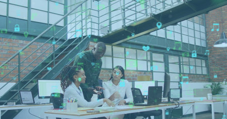 Image of network of digital icons over diverse colleagues discussing together at office. Global...