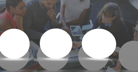 Image of spots over diverse business people in office. Global business and digital interface concept...