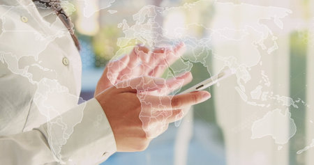 Image of world map and data processing over asian businesswoman using smartphone in office. Global business, communication, computing and data processing concept digitally generated image.の写真素材