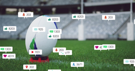Image of social media icons foating against close up of a rugby ball on a stand in the stadium....