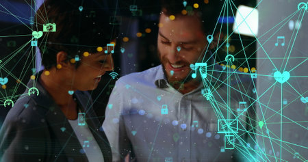 Image of network of connections with icons over people working together. global networking technology digital interface connection communication concept digitally generated image.の写真素材