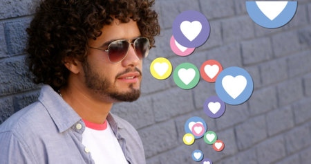 Image of social media heart icons and numbers over man drinking coffee. global social media, digital interface, technology and connections concept digitally generated image.の写真素材
