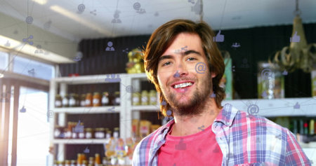 Image of icons connected with lines over caucasian man talking on cellphone. Digital composite,...