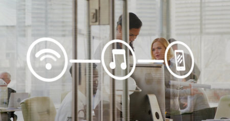 Image of flowchart of icons over diverse coworkers discussing and working in office. Digital composite, multiple exposure, communication, business and wireless technology concept.の写真素材