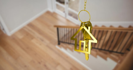 Image of gold key and house key ring over blurred house interior. real estate, developer business and moving house concept digitally generated image.の写真素材