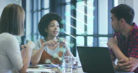 Image of dna strand spinning over diverse business people in office. global research, business,...