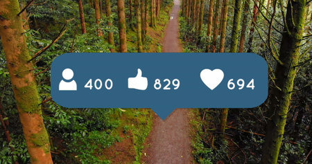 Image of social media icons on speech bubble over aerial view of caucasian man running in forest....