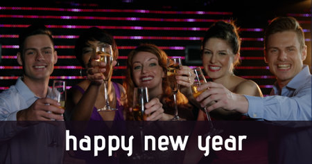 Group of friends holding champagne, all smiling at camera. Enjoying festive atmosphere with colorful...
