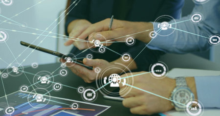 Image of connected dots, midsection of caucasian coworkers discussing reports on digital tablets....