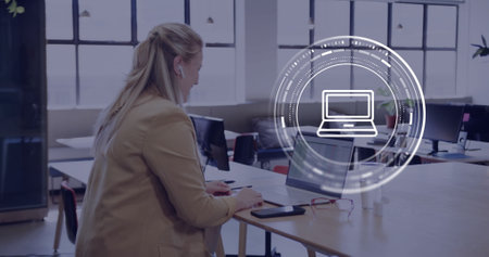 Image of scope, computer icon and data processing over caucasian businesswoman using laptop. Global...