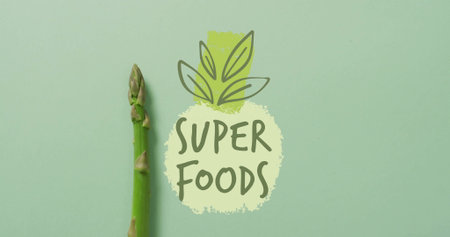 Asparagus spear with SUPER FOODS text and leaf image on green background. Nutrition, health, vegetables, wellness, diet, organicの写真素材